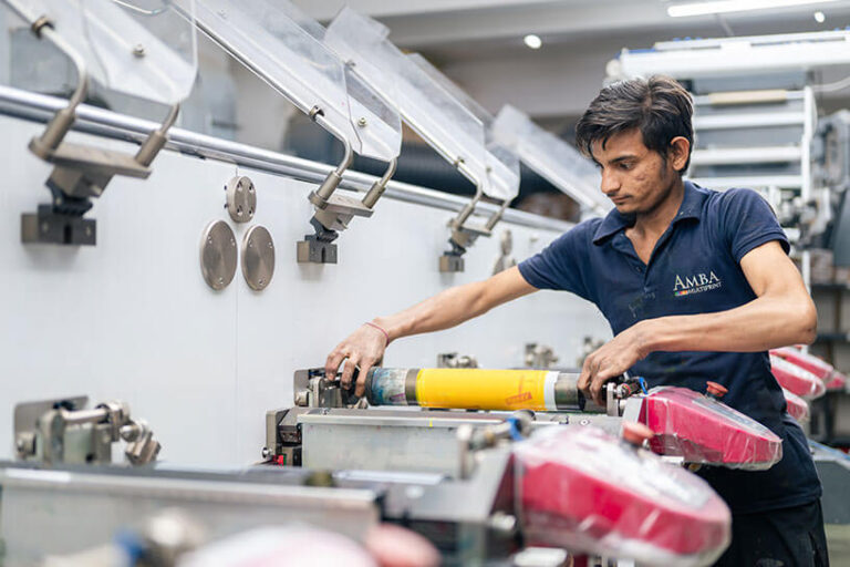 A-man-is-working-with-printing-color-roll-in-AMBA-offset-printing-packaging